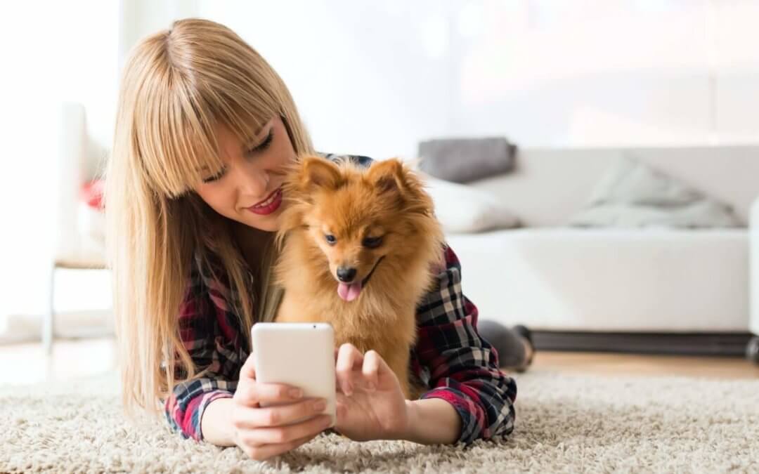 Woman and her dog using telemedicine.